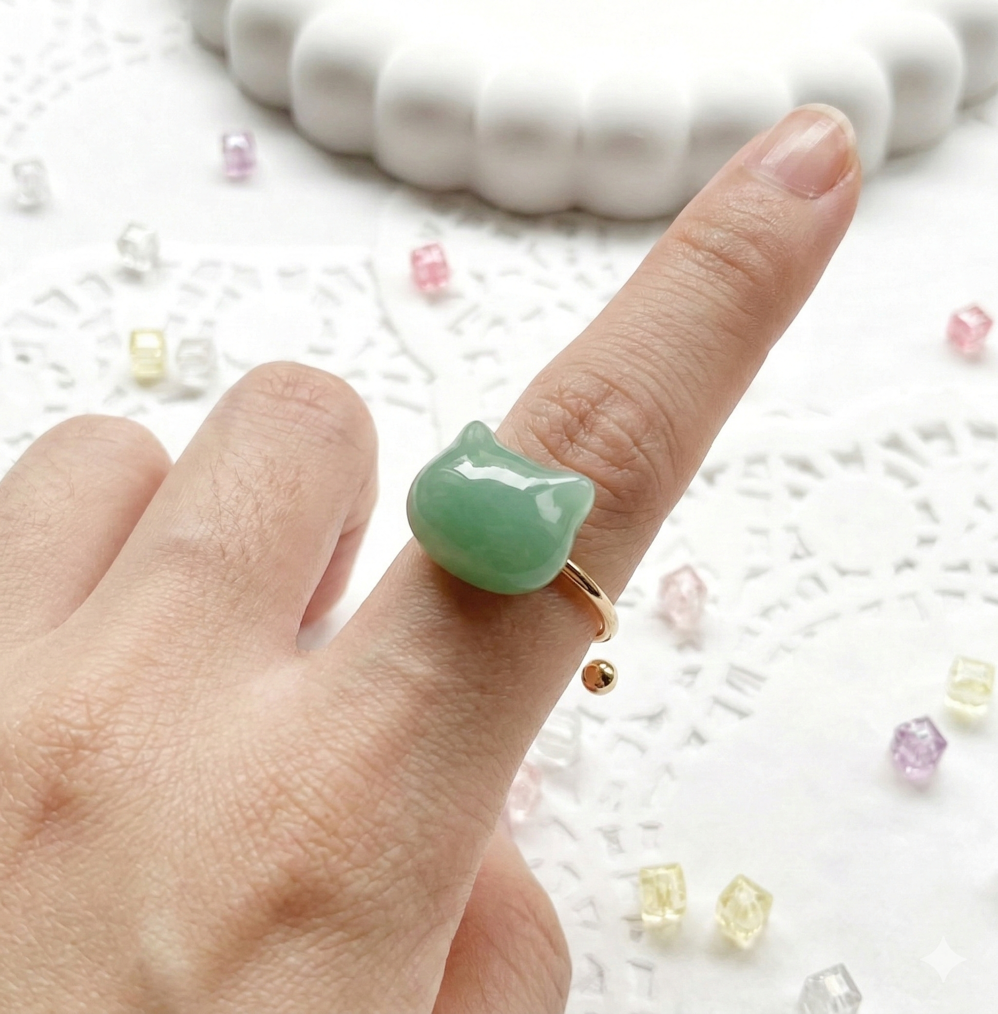 Green floral ring worn on hand